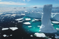 Towering,Melting,Iceberg,In,Arctic,Icy,Ocean.,Snow,Covered,Glacier