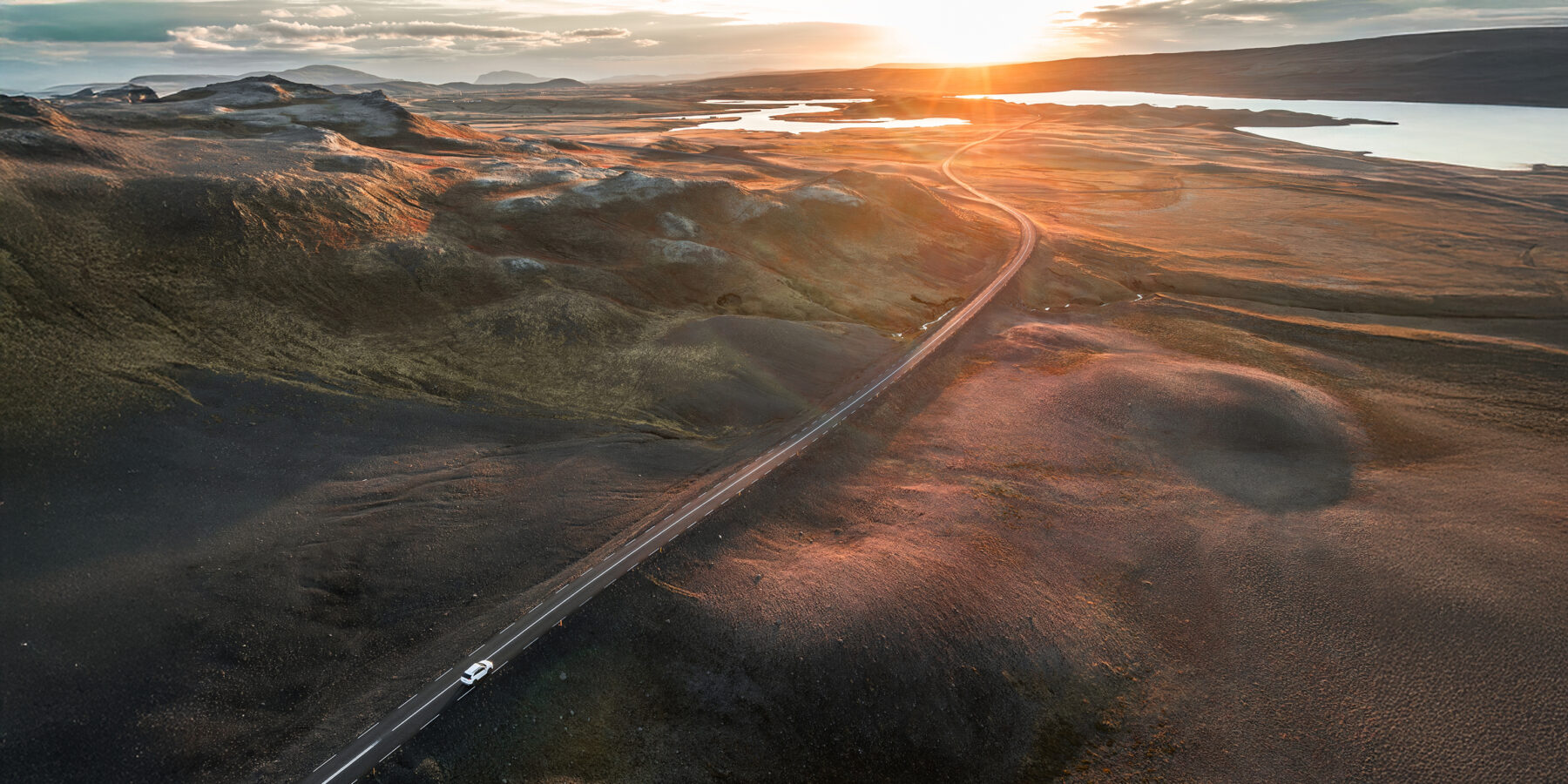 Cinematic,Aerial,Image,Of,A,Car,Driving,On,An,Empty